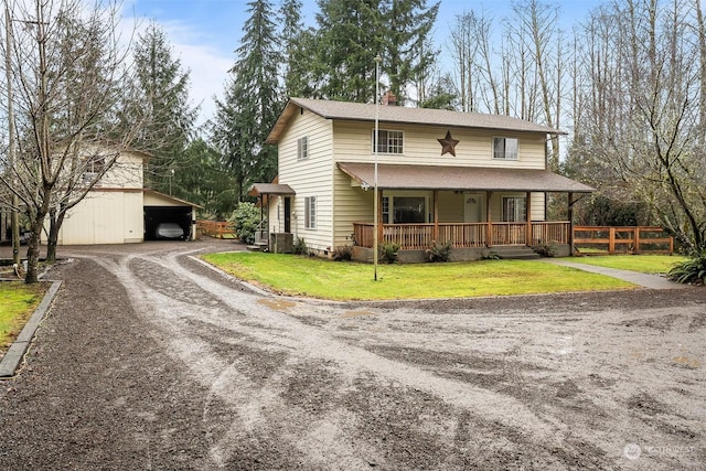 view of front of house with an outdoor structure, central AC, covered porch, and a front yard