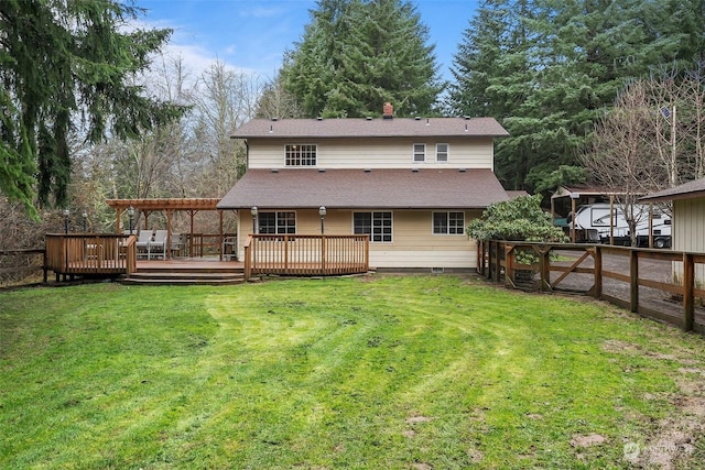 rear view of property featuring a pergola, a deck, and a lawn