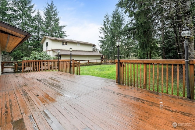 wooden deck with a lawn