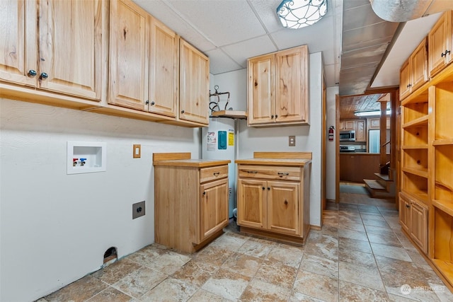 laundry room featuring hookup for an electric dryer, hookup for a washing machine, electric water heater, and cabinets