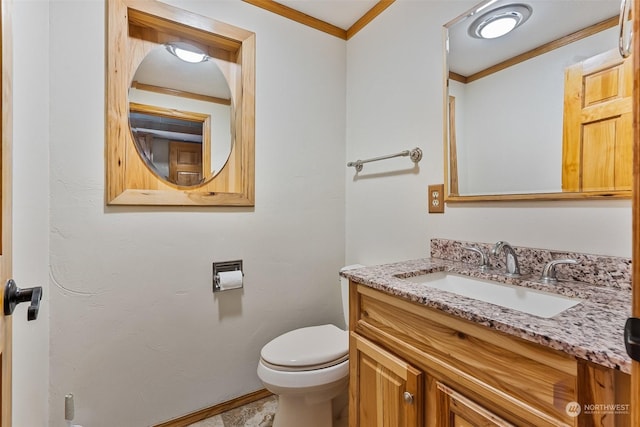 bathroom with toilet, vanity, and ornamental molding