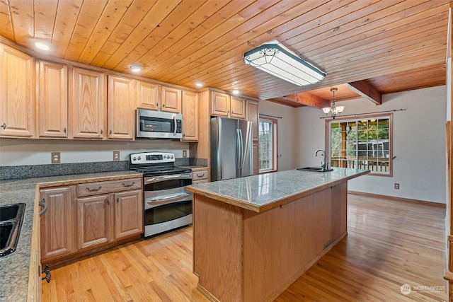 kitchen featuring beam ceiling, stainless steel appliances, a chandelier, light hardwood / wood-style floors, and a kitchen island with sink