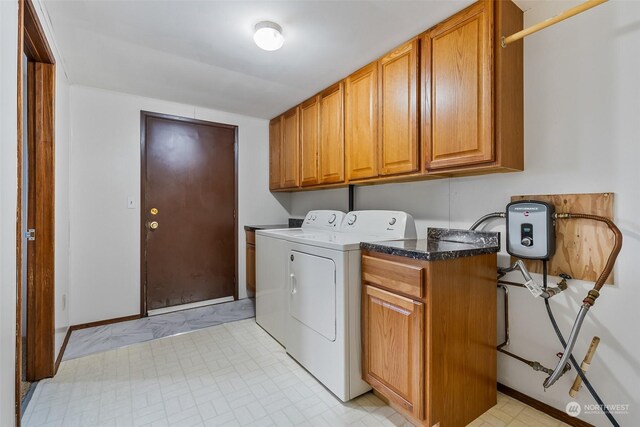 washroom featuring cabinets and separate washer and dryer