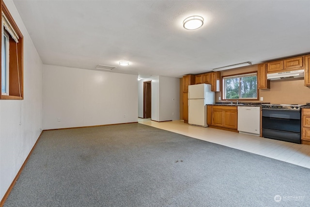 kitchen with white appliances, sink, and light carpet