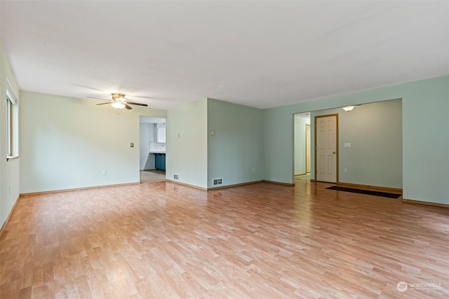 unfurnished room with light wood-type flooring and ceiling fan