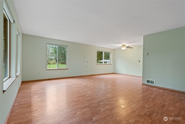 empty room featuring ceiling fan and light hardwood / wood-style floors