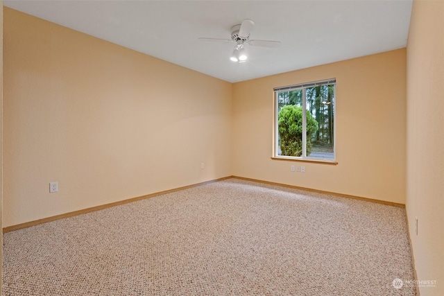 spare room featuring carpet flooring and ceiling fan