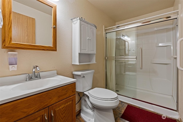 bathroom featuring vanity, toilet, and an enclosed shower