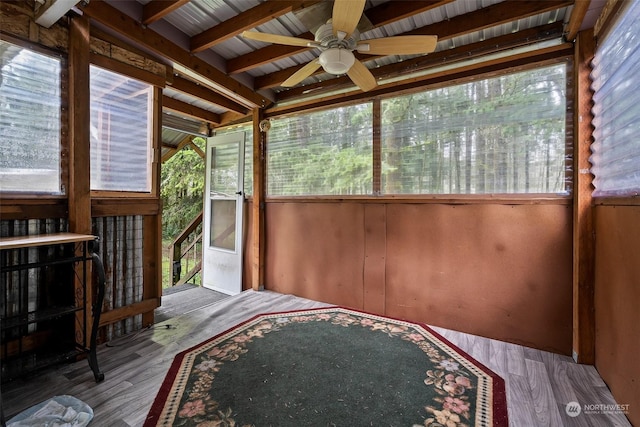 unfurnished sunroom featuring ceiling fan