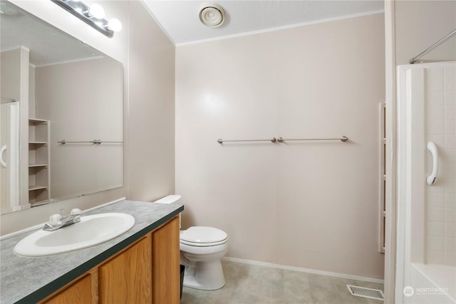 bathroom with vanity, toilet, and ornamental molding