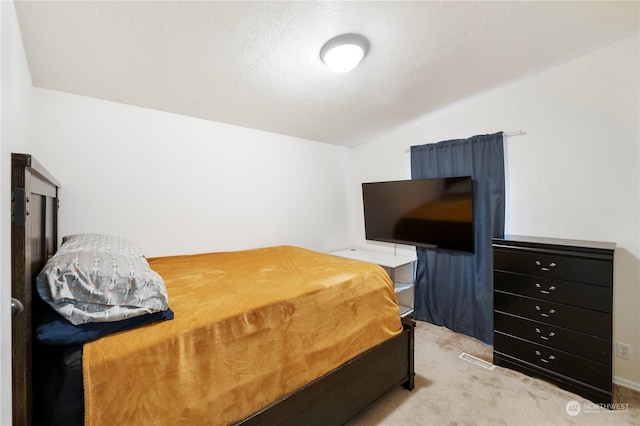 bedroom featuring light carpet and lofted ceiling