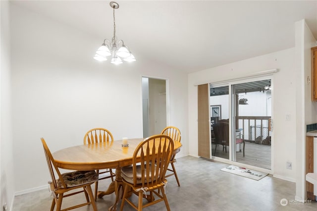 dining space with vaulted ceiling and an inviting chandelier