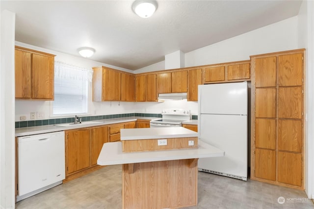 kitchen with vaulted ceiling, sink, a kitchen island, and white appliances