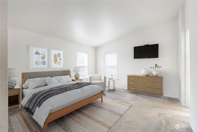 carpeted bedroom featuring lofted ceiling