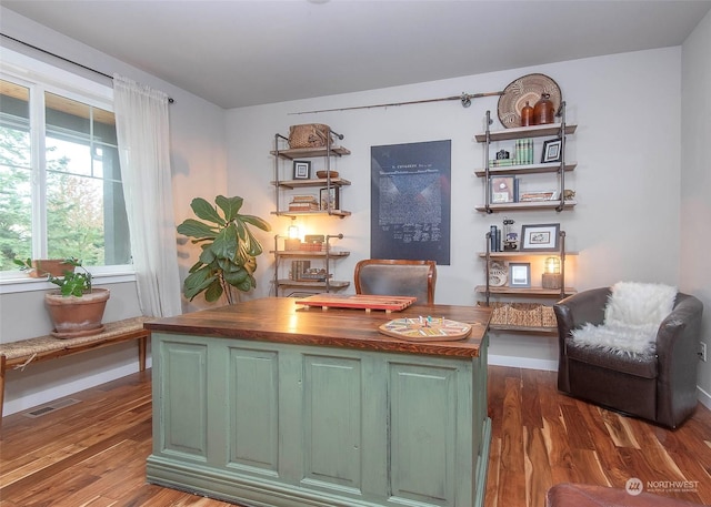 home office with dark wood-type flooring