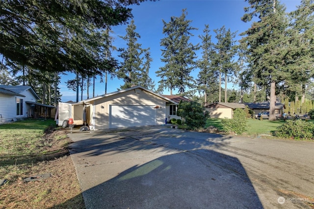 view of front of property with a garage and a front lawn