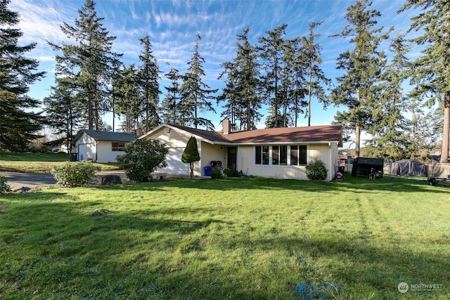 ranch-style home with a garage and a front lawn