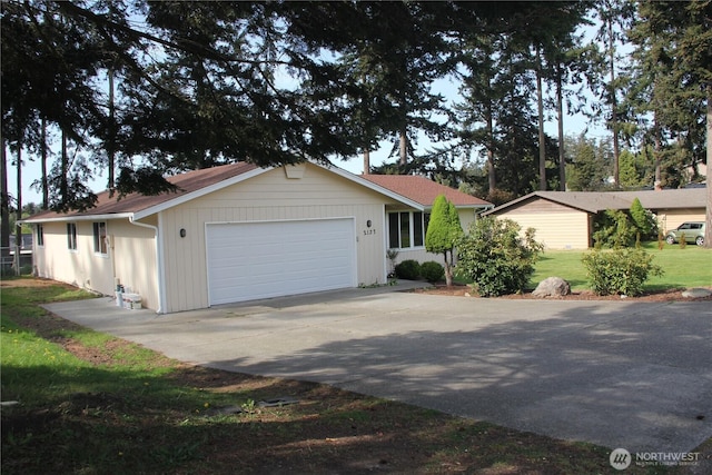 ranch-style house featuring driveway and an attached garage