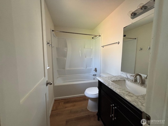 full bathroom with toilet, vanity, shower / bathtub combination, and wood finished floors