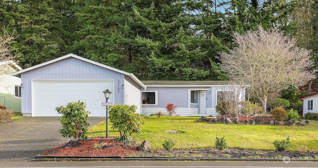 view of front of property with a garage and a front yard