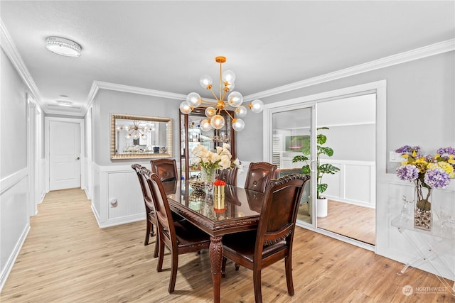 dining area featuring light wood-type flooring, an inviting chandelier, and crown molding