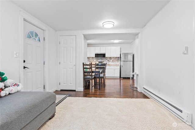 living room with baseboard heating and dark hardwood / wood-style flooring