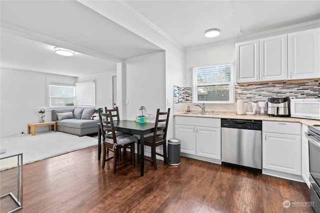 kitchen featuring decorative backsplash, white cabinetry, stainless steel dishwasher, and sink