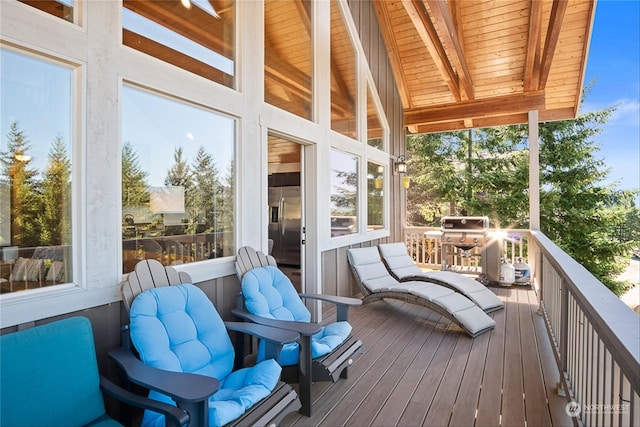 sunroom with lofted ceiling with beams and wood ceiling