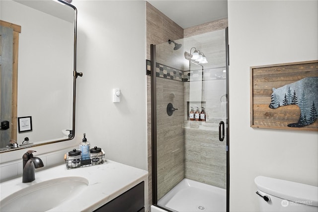 bathroom with vanity, toilet, and an enclosed shower