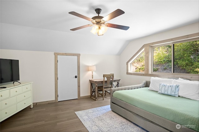 bedroom featuring ceiling fan, hardwood / wood-style floors, and lofted ceiling