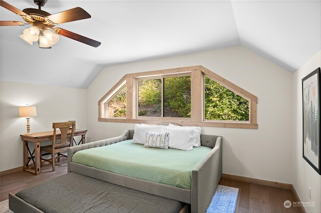 bedroom with ceiling fan, wood-type flooring, and lofted ceiling