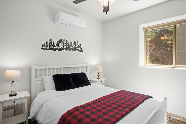 bedroom with a wall unit AC and ceiling fan