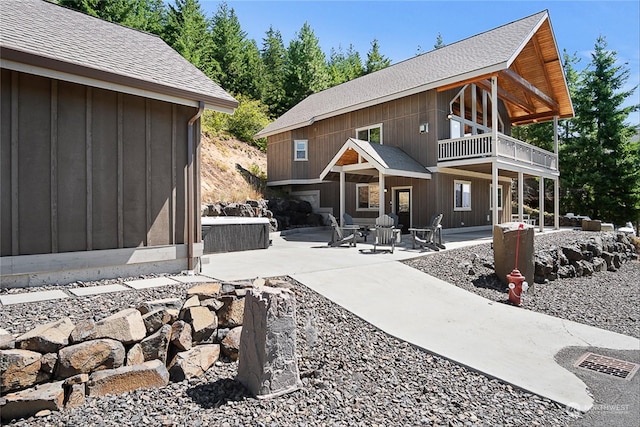 rear view of house with a patio area and a balcony