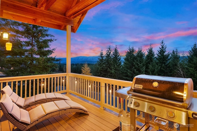 deck at dusk with a grill and a mountain view