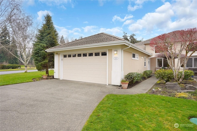 view of front of property featuring a front lawn and a garage