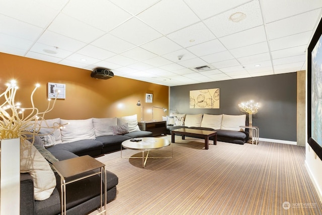 carpeted living room featuring a paneled ceiling