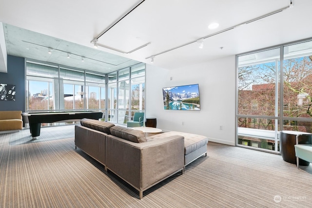 living room with expansive windows, track lighting, and pool table