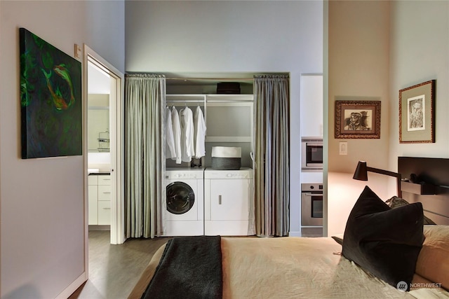 washroom featuring wood-type flooring and independent washer and dryer