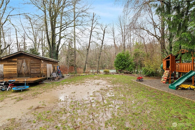 view of yard with a playground, a shed, and a trampoline