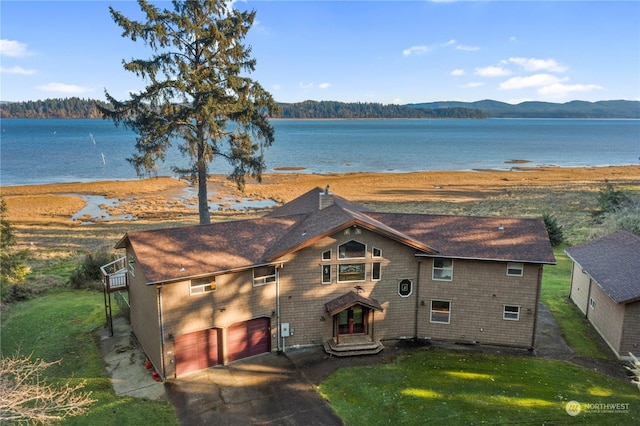 exterior space with a water and mountain view