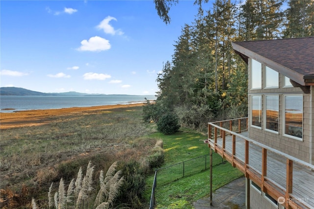 view of yard featuring a deck with water view