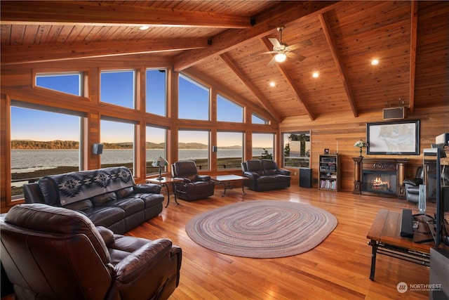 living room with light hardwood / wood-style floors, wood ceiling, a water view, high vaulted ceiling, and beam ceiling