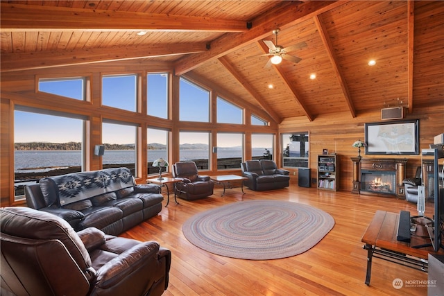 living room with wood ceiling, a water view, high vaulted ceiling, light hardwood / wood-style flooring, and beam ceiling