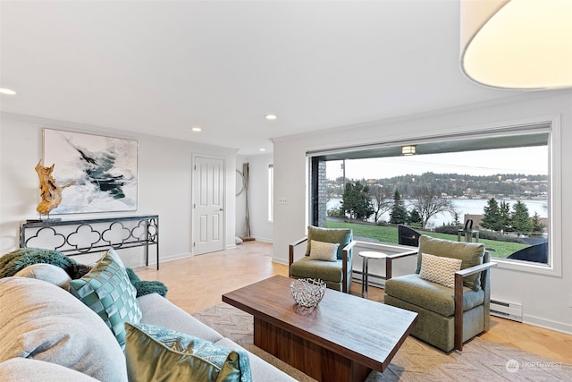 living area with baseboards, baseboard heating, and recessed lighting