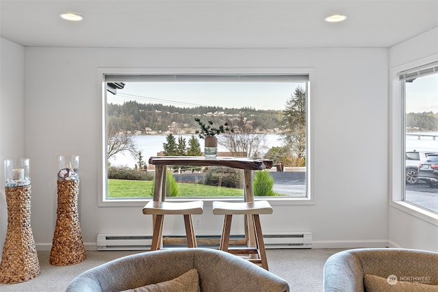 interior space featuring recessed lighting, a baseboard heating unit, a water view, carpet flooring, and baseboards