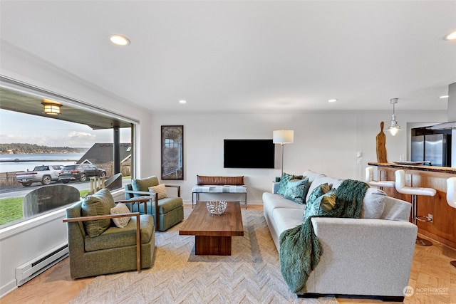 living room with baseboards, baseboard heating, and recessed lighting