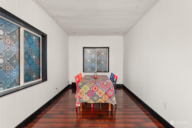 dining area with dark hardwood / wood-style flooring, crown molding, and a textured ceiling