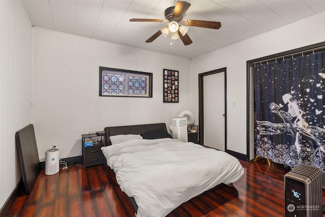 bedroom with ceiling fan and dark hardwood / wood-style floors