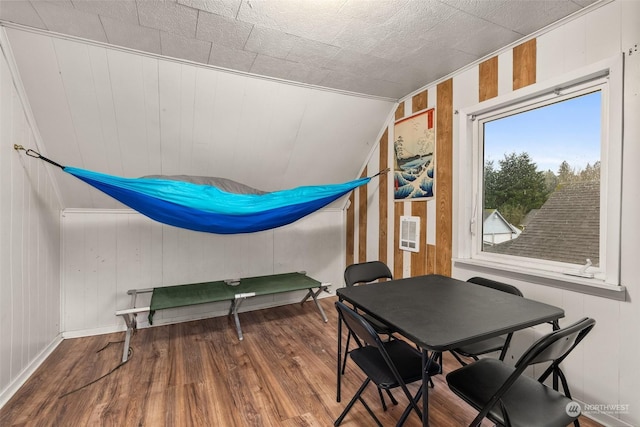 interior space featuring hardwood / wood-style floors and vaulted ceiling