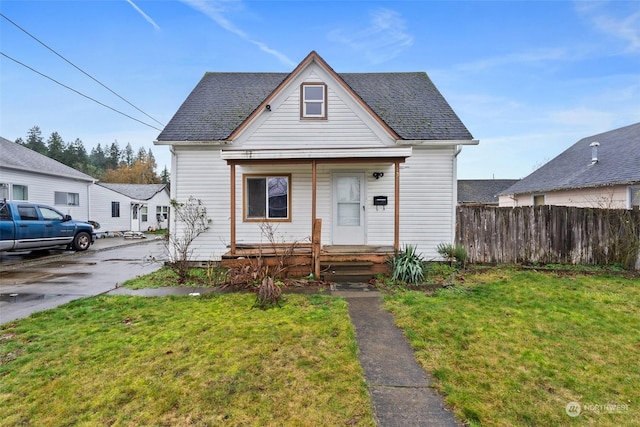 bungalow featuring a front yard and covered porch